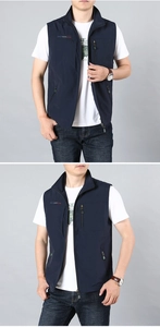 Detail view of a navy blue quick-dry outdoor vest with multiple zipper pockets