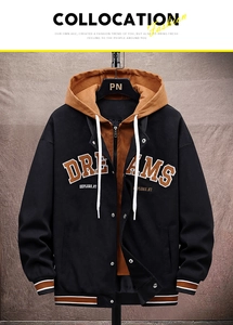Detail of hooded jacket with DREAMS patch embroidery and zip closure on dark wall
