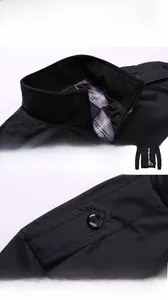 Detail of men's jacket showing ribbed stand collar, plaid lining and decorative shoulder tabs