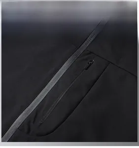 Detail of men's casual black jacket showing vertical zippered chest pocket and premium texture