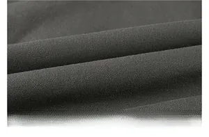 Detailed macro view of heavy-duty dark grey washed cotton fabric with thick woven texture
