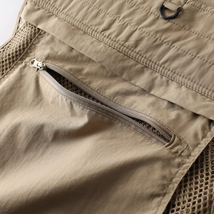 Detail of khaki tactical vest featuring zipper pocket and breathable mesh lining