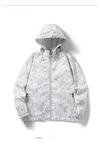 Detail of hooded windbreaker featuring tropical leaf print and secure zipper pockets