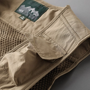 Detail of khaki tactical vest featuring mesh lining and brand label on collar