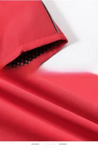 Detail of red outdoor vest showing reflective silver strip and breathable mesh lining