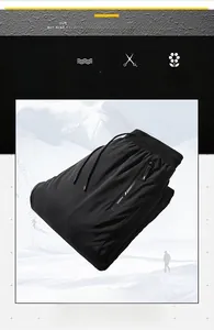 Close-up of black insulated winter pants featuring elastic drawstring waist and side zip pocket