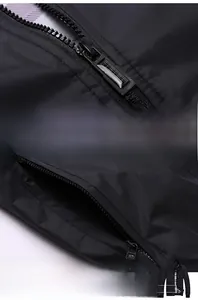 Detailed macro view of the black jacket featuring a durable zipper and side zip pocket