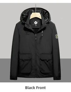 Detail of black hooded windbreaker jacket featuring zipper pockets and durable fabric