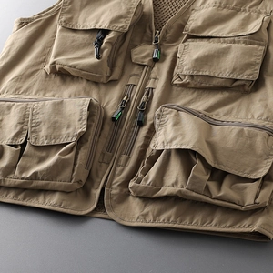 Detailed close-up of tactical khaki multi-pocket vest with breathable mesh lining