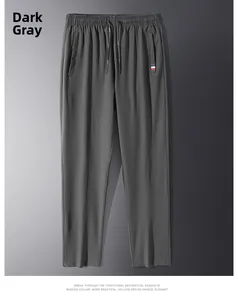 Detail of grey men's trousers featuring elastic waistband and tricolor ribbon pocket