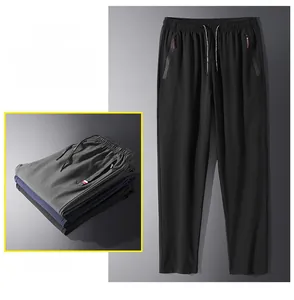 Detail of men's casual pants showing elastic waistband and secure zippered pockets