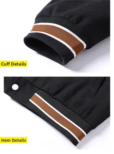 Detail of striped rib knit cuffs and snap button hem on a black baseball jacket