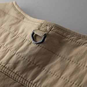 Detail showing tactical khaki quilted vest neck with durable black D-ring hook hardware