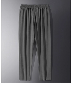 Detailed view of elastic waistband on gray casual trousers with smooth fabric texture
