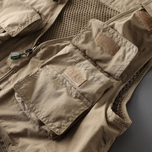 Macro detail of khaki tactical vest featuring multi-pockets and durable stitching