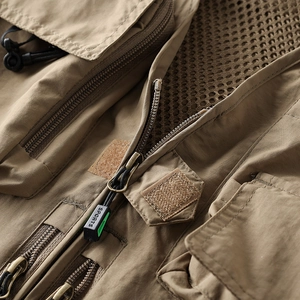 Detailed close-up of khaki tactical vest featuring mesh lining and sports zipper pulls