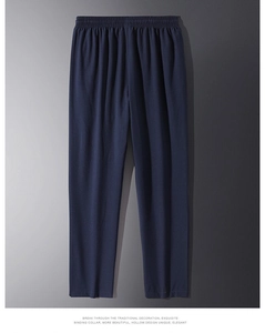 Detail showing elastic high-waist waistband and premium fabric of men's blue casual pants