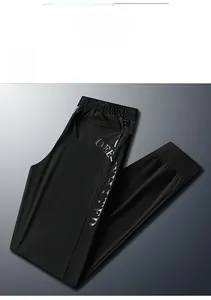 Detail of men's black ice silk joggers featuring side mesh panels and zippered pockets