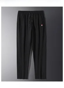 Detail view of black casual joggers featuring elastic waist and tri-color ribbon trim