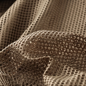 Detailed macro view of the breathable brown honeycomb mesh fabric for tactical vests