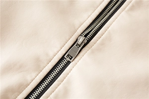 Detailed macro view of the silver metal zipper and textured lychee pattern leather