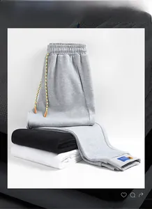Detail of three cotton joggers featuring colorful drawstrings and ankle elastic cuffs