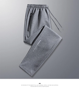 Detailed view of gray joggers with elastic waistband and decorative zipper pocket