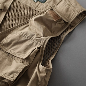 Detail of khaki tactical vest featuring breathable mesh lining and multi-pocket design