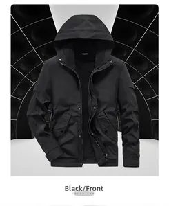 Close-up of black tactical jacket with hood featuring dual zip and snap button closure