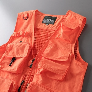 Macro detail of breathable mesh lining and durable fabric on orange tactical outdoor vest