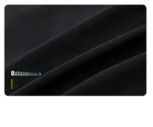 Detail view of premium black windproof fabric showing soft texture and thick material