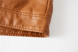 Macro shot of high-quality brown PU leather jacket with detailed double stitching craft