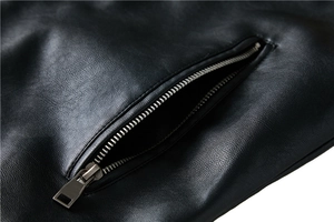 Close-up of black pebble grain leather jacket featuring a high-quality metal zipper detail