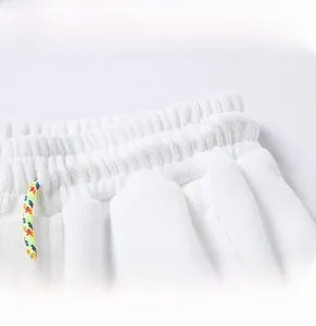 Detail of elastic waist with colorful braided drawstring on white casual sports pants