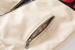 Detail of beige faux leather jacket with zip pocket and quilted lining craftsmanship