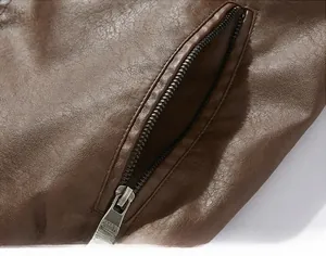 Detail of a brown leather jacket featuring a side pocket with a metallic zipper closure