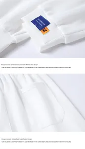Detailed macro view of white joggers featuring ribbed cuffs and blue embroidered logo labels