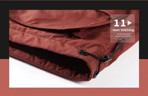 Detail view of the brick red jacket hem with adjustable black drawstring and plastic toggle