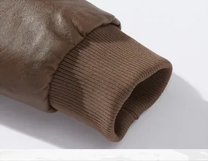 Detail of brown leather jacket cuffs featuring ribbed knit design for windproof protection