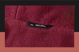 Close-up of burgundy fleece jacket collar showing high-quality stitching and size label