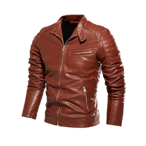Detail of reddish brown faux leather jacket featuring quilted shoulder stitching and zippers