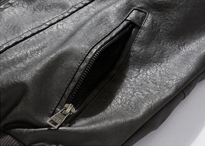 Detail of premium black PU leather jacket showing precision stitching and zipper pocket