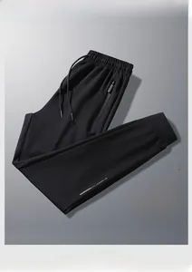Detail of men's black joggers with elastic drawstring waist and side zip pocket