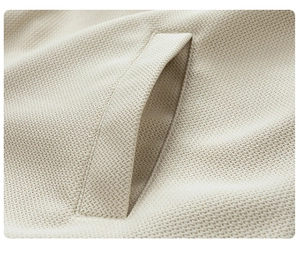 Detailed view of beige waffle weave fabric texture and reinforced side pocket stitching