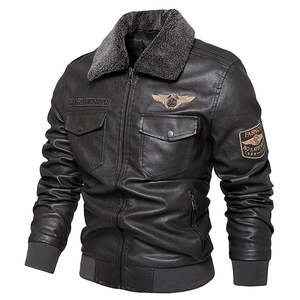 Detail of black faux leather biker jacket with gray faux sheepskin collar and arm patch