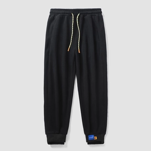 Men's casual black joggers with elastic drawstring waist and cuffed ankles for sports