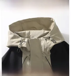 Detail of hooded neckline with adjustable drawstring and windproof flap on hiking jacket