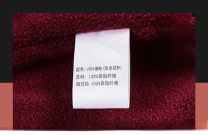 Macro detail of washing label on thermal fleece lining of burgundy men's jacket