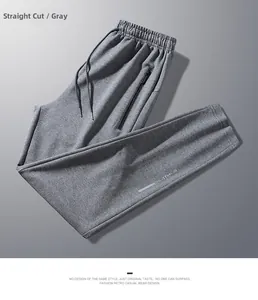 Detail view of grey knit jogger pants featuring drawstring waist and zipped pocket