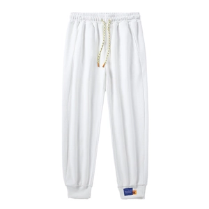 White casual drawstring sweatpants with multi-color cord and ribbed ankle cuffs